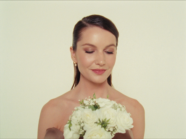 Client holding flowers after her Beauty House service