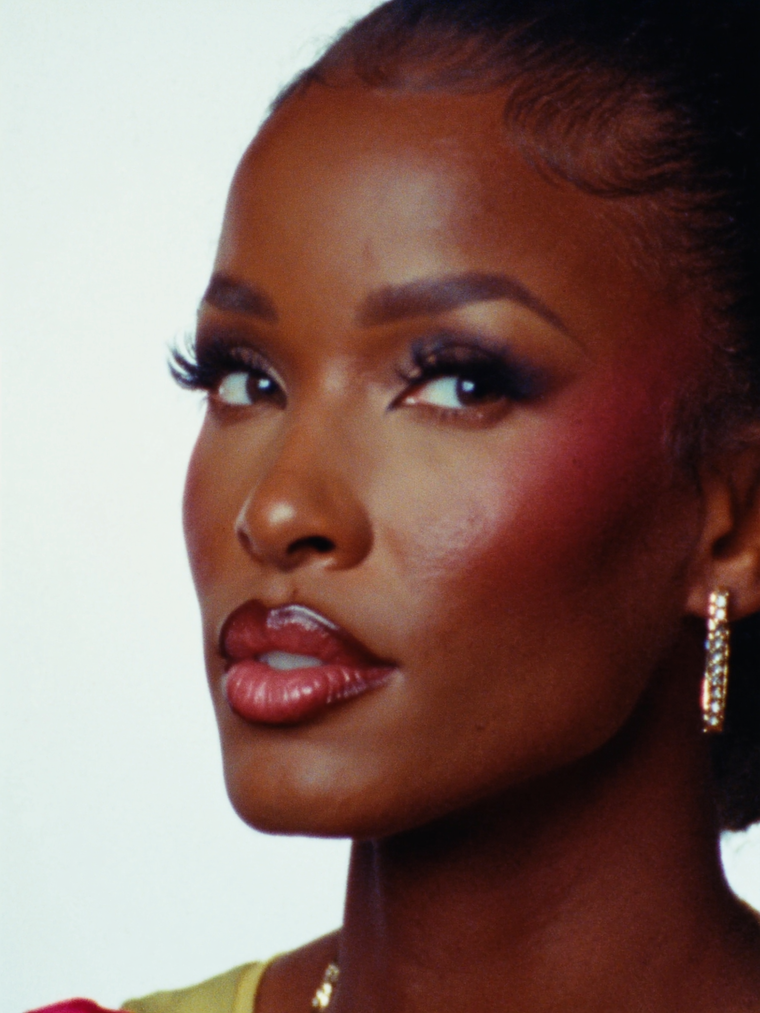 Finished glam makeup portrait with warm studio lights.
